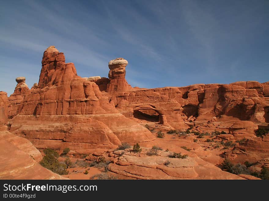 View of the red rock formations in Arches National Park with blue sky�s and clouds. View of the red rock formations in Arches National Park with blue sky�s and clouds