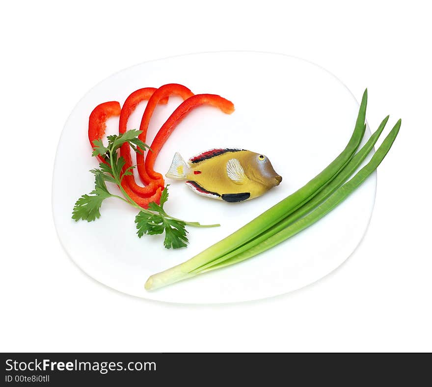 Concept toy fish on a plate isolated over a white background