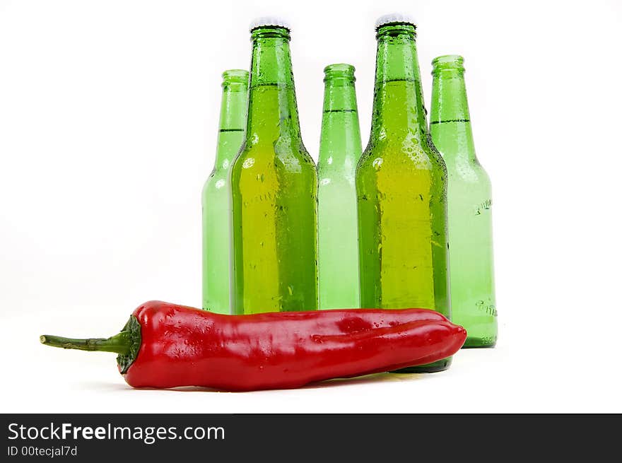 Cold beer botle over spicy hot chili. Cold beer botle over spicy hot chili