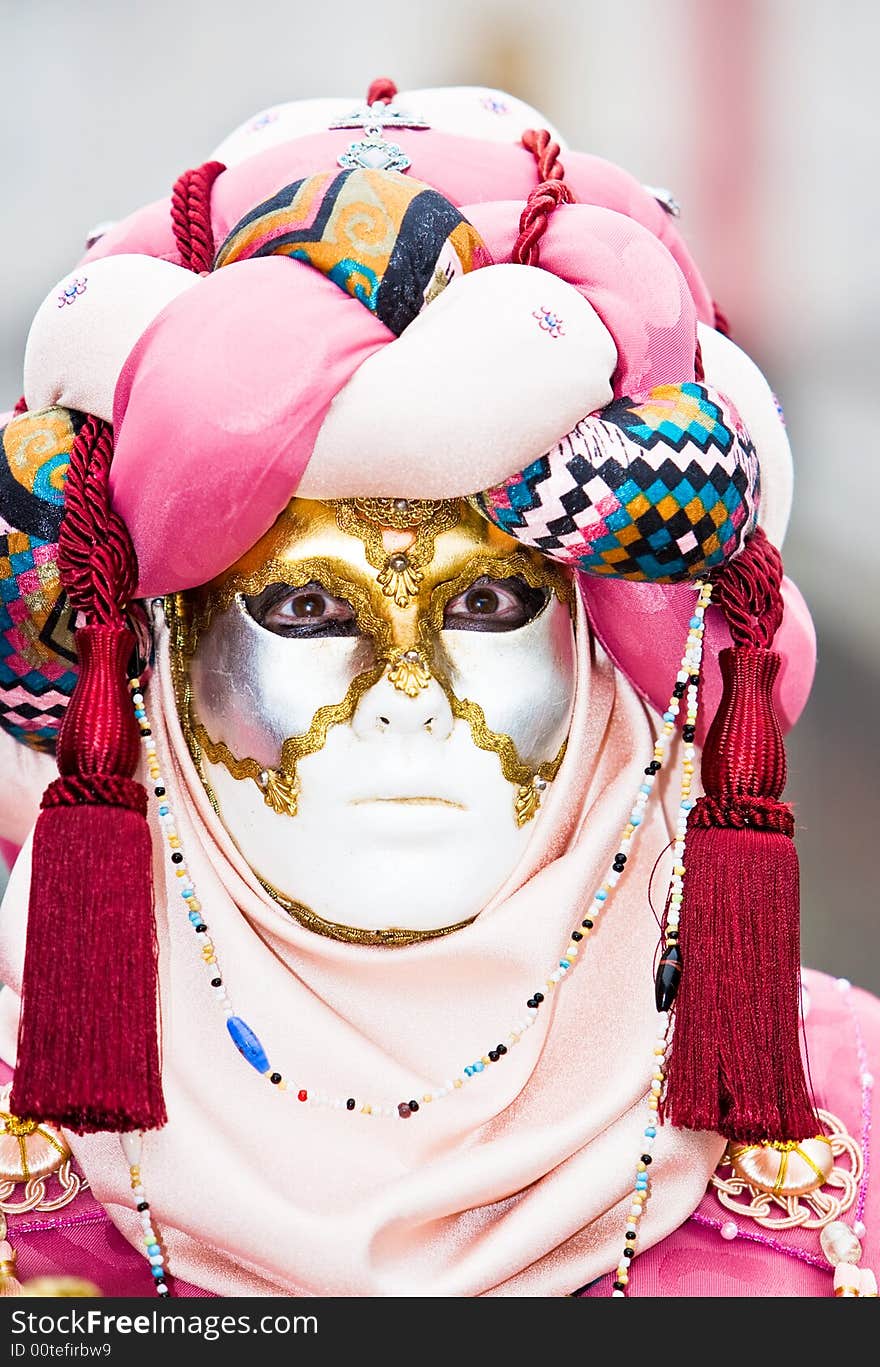 A pink and red mask at the Venice Carnival