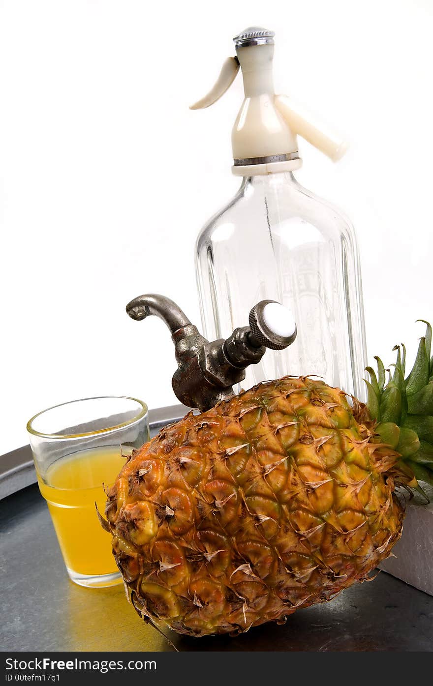 Juicy ananas with tap and soda bottle