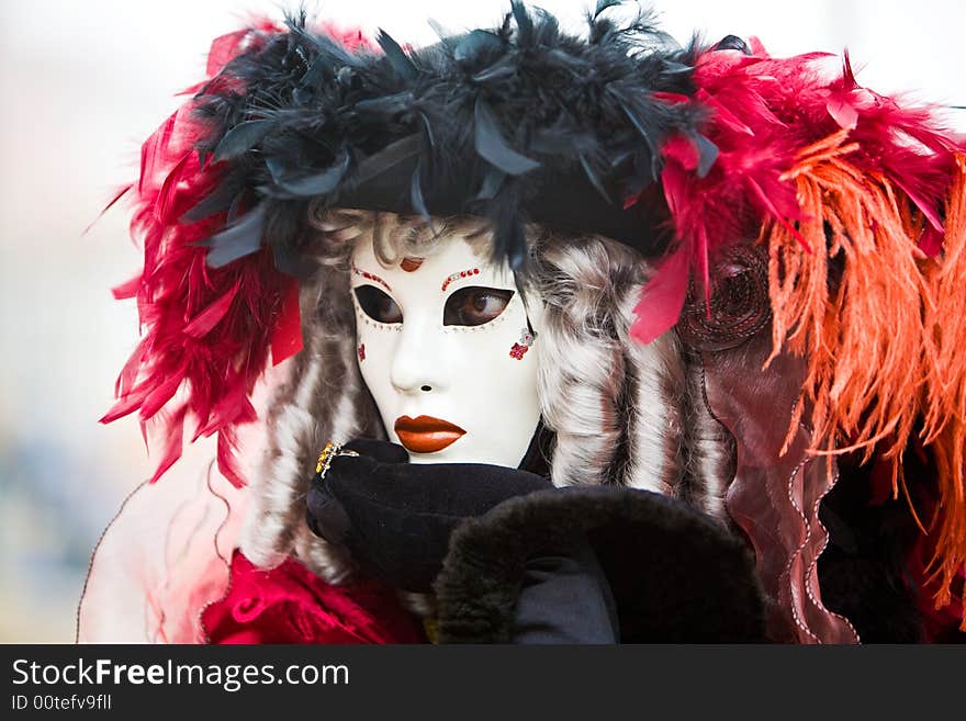 Black and red hat with white mask at the Venice Carnival. Black and red hat with white mask at the Venice Carnival