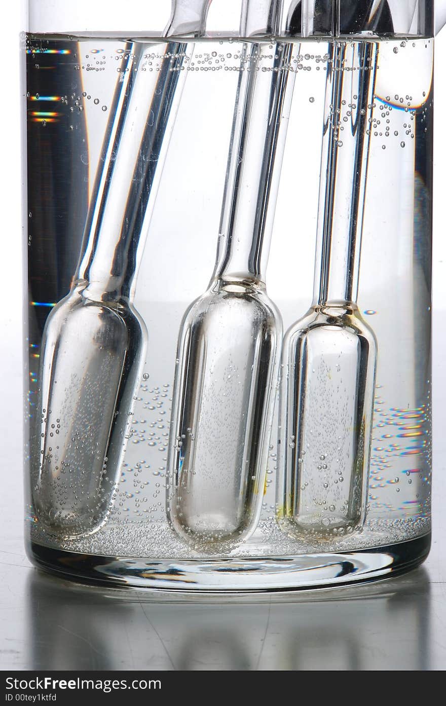 Chemistry tube on glass table, with grey background