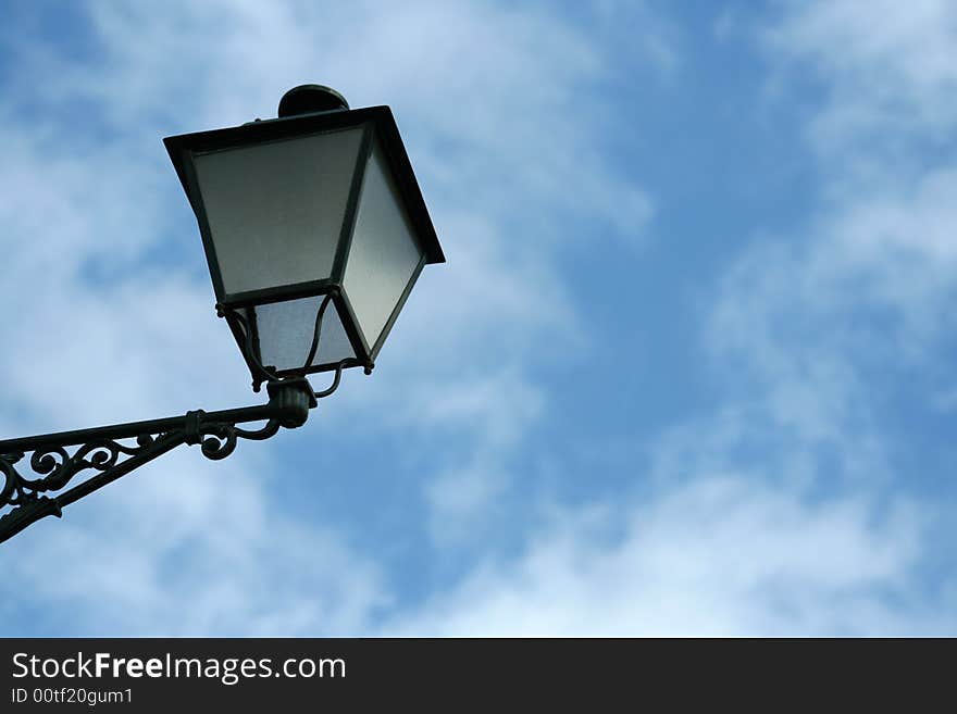 Old lamp stand under a blue sky. Old lamp stand under a blue sky.