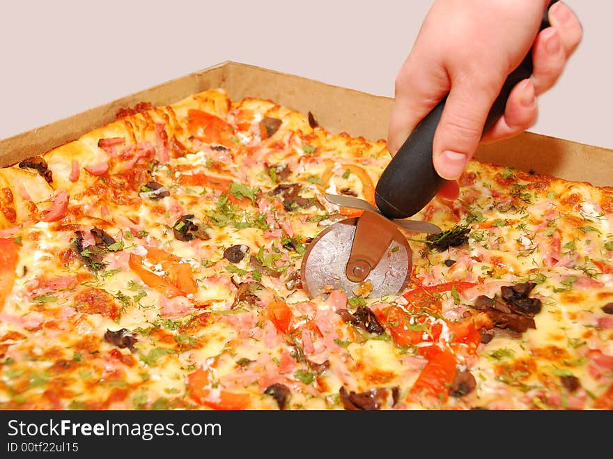 Girl cut pizza in box isolated on white background