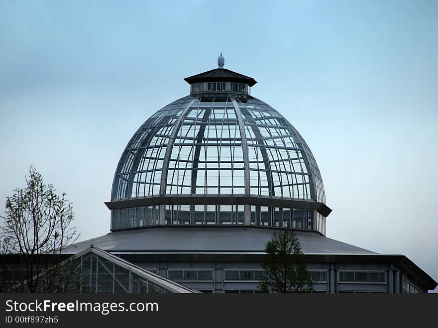 A glass topped building against blue sky. A glass topped building against blue sky