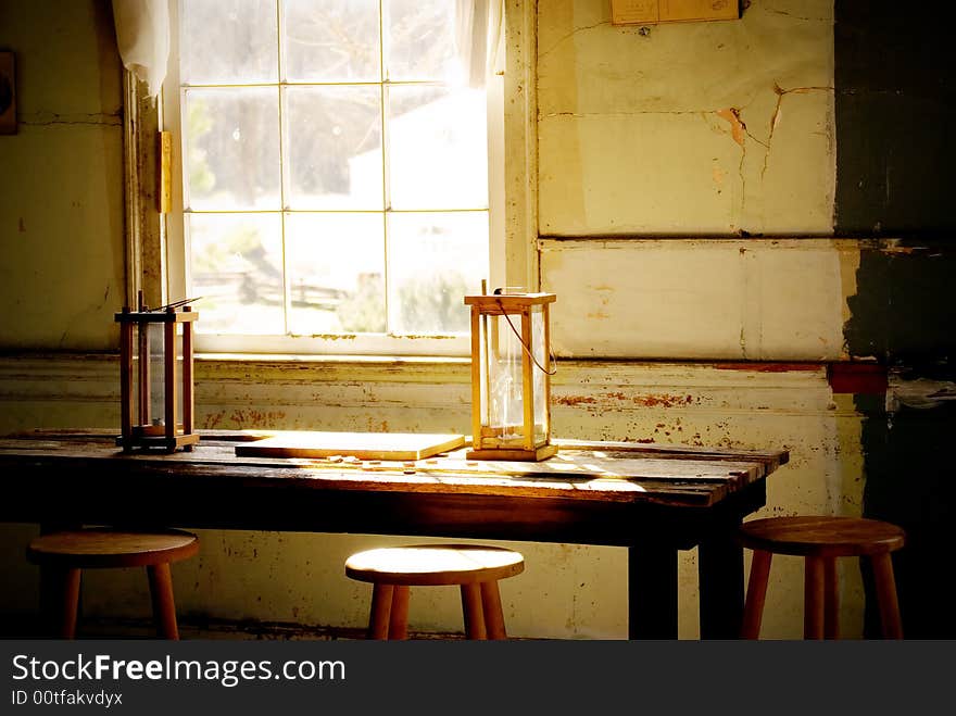 Two old candle reading lamps by a window. Two old candle reading lamps by a window