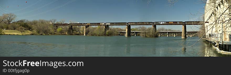 A long railroad bridge with graffiti covering it's sides. A long railroad bridge with graffiti covering it's sides.