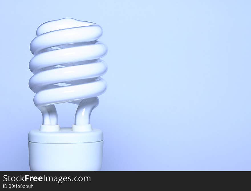 - an energy saving light bulb with room for text; shot in a light tent; blue toning derives from white balance setting artificial light. - an energy saving light bulb with room for text; shot in a light tent; blue toning derives from white balance setting artificial light