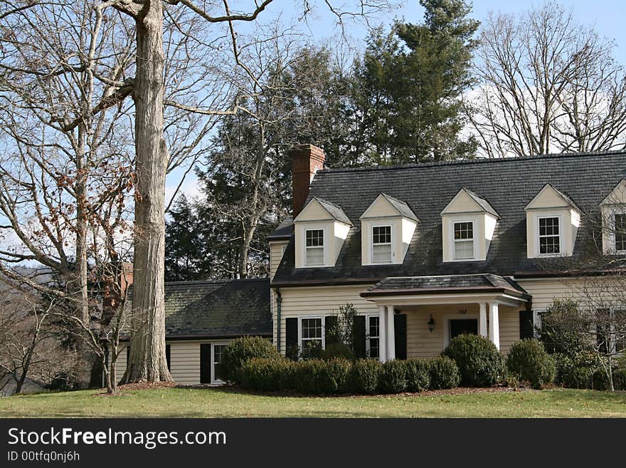 A large modern American home with dorme windows. A large modern American home with dorme windows.