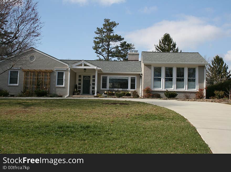 A modern home with concrete drive.