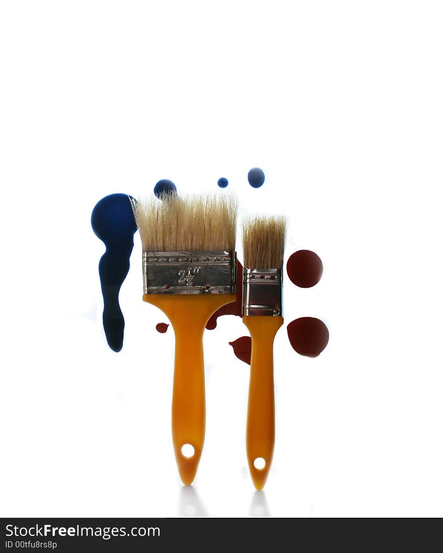 Two brushes on a background of spots of a paint. Two brushes on a background of spots of a paint