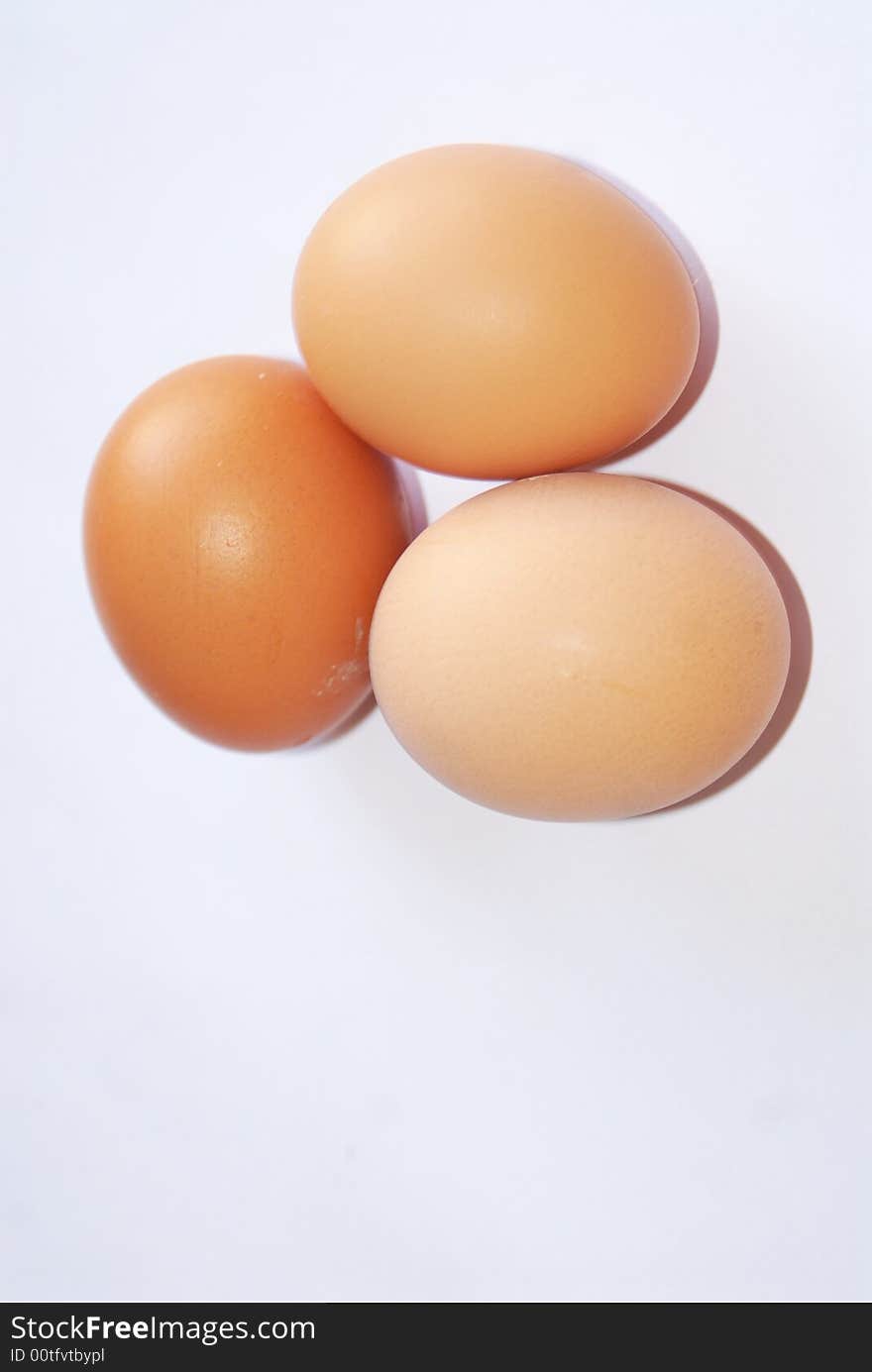 Three fresh eggs on white background