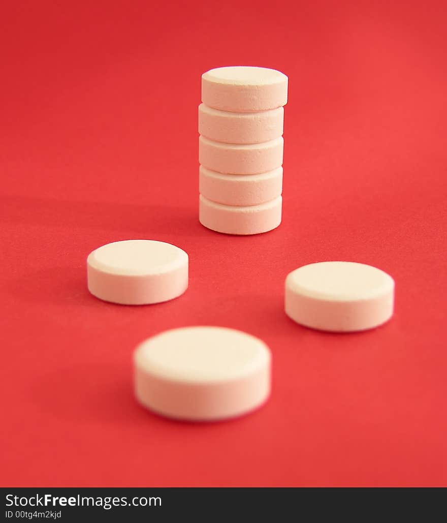 White tablets on the red background.
Focus on the back plane. White tablets on the red background.
Focus on the back plane