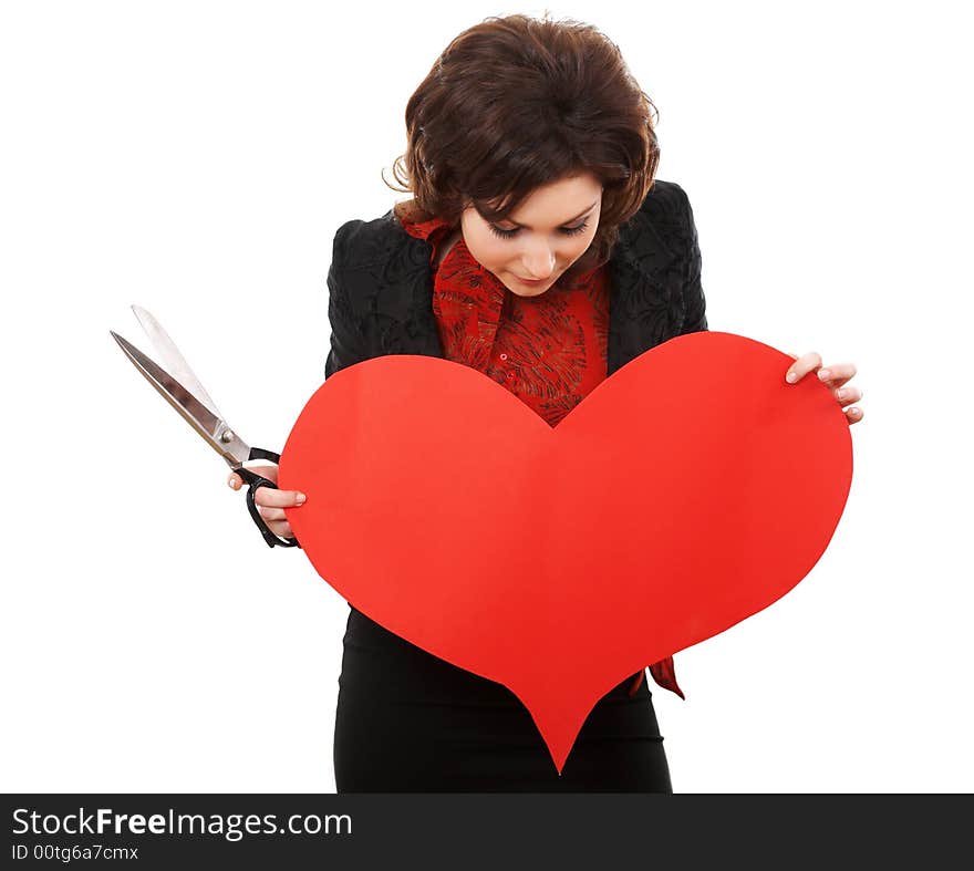 Girl with scissors looking onto a paper heart