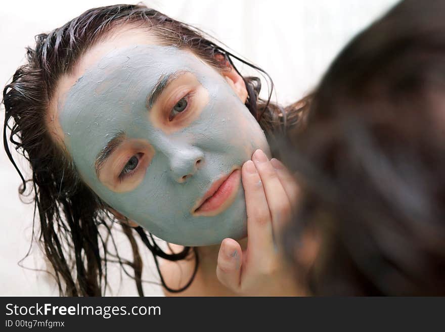 Woman putting a mud mask