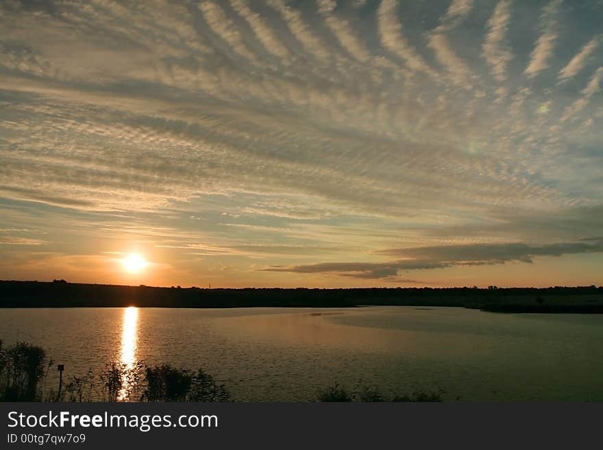 Sunset on the lake with strange clouds