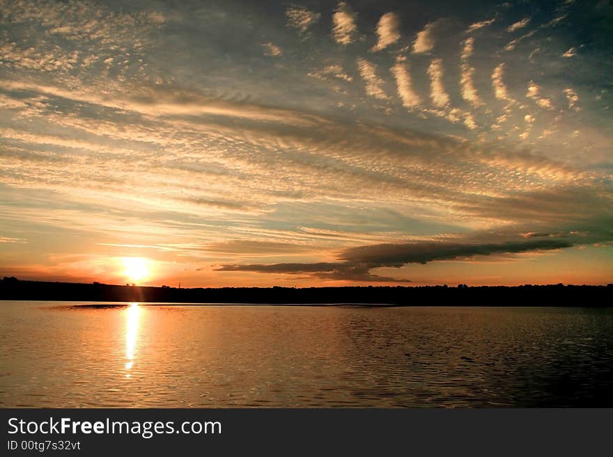 Sunset on the lake with strange clouds