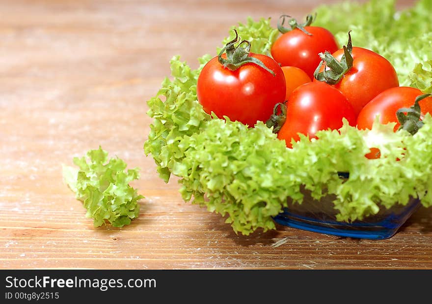 Fresh salad and a  tomato