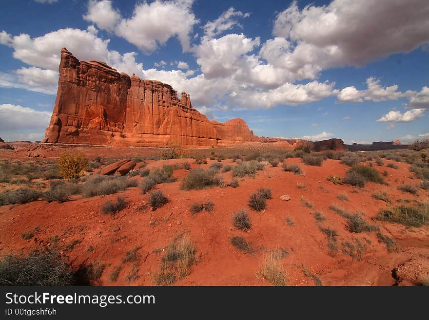 View of the red rock formations in Arches National Park with blue sky�s and clouds. View of the red rock formations in Arches National Park with blue sky�s and clouds