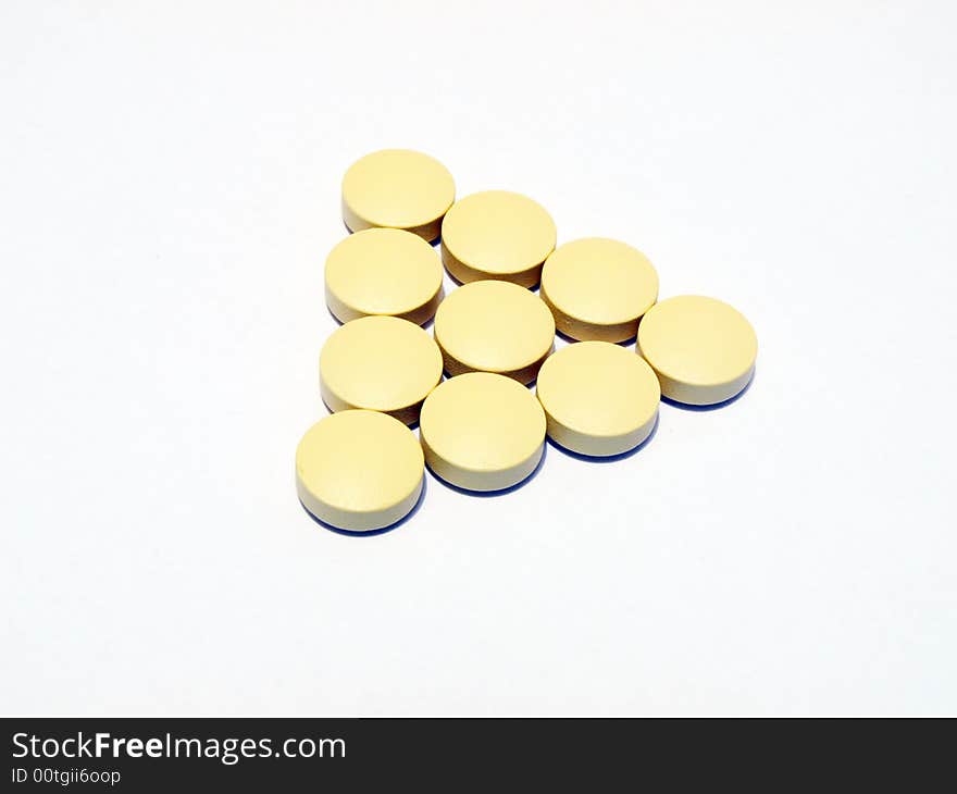 Photo of yellow pills on white background. Photo of yellow pills on white background