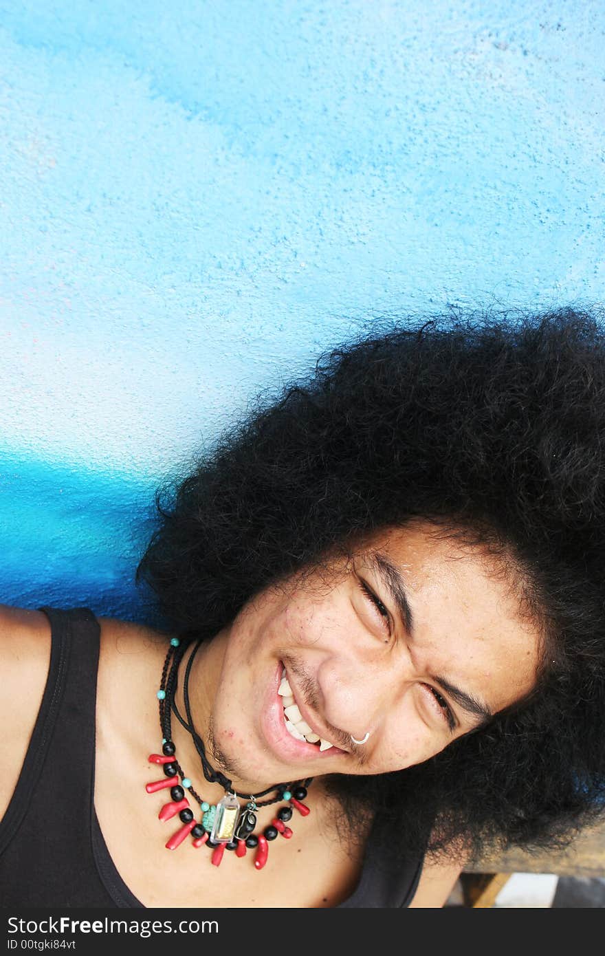 Thai man with a big afro hairstyle isolated on white.