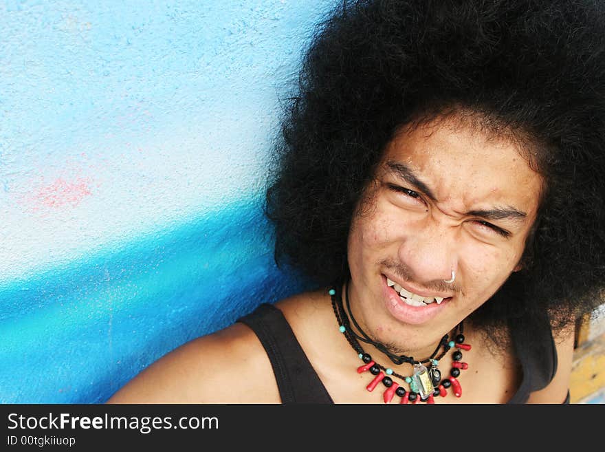 Thai man with a big afro hairstyle isolated on white.