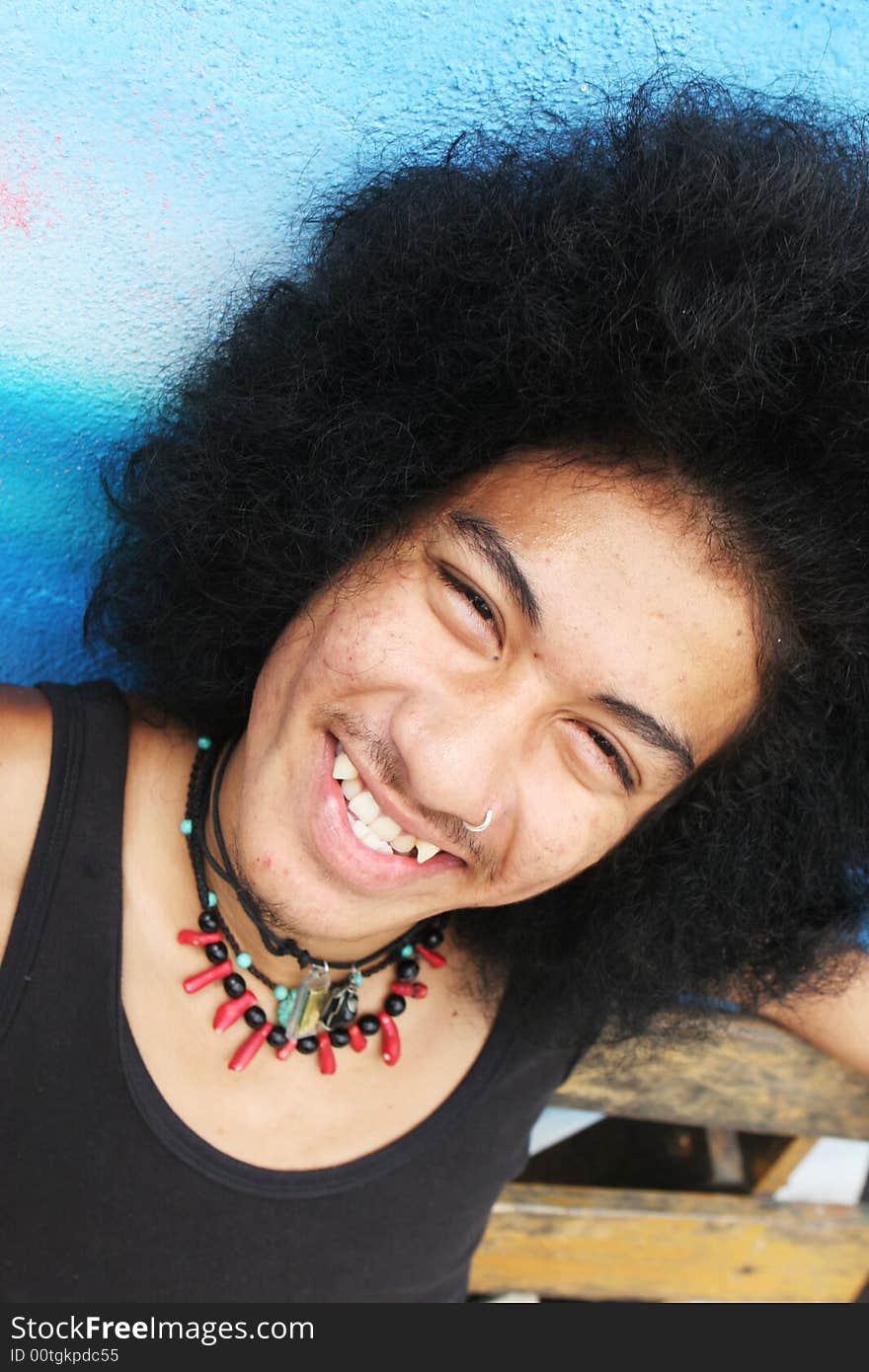 Thai man with a big afro hairstyle isolated on white.