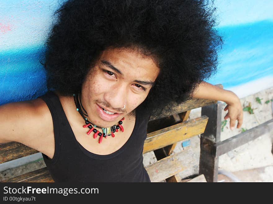 Thai man with a big afro hairstyle isolated on white.