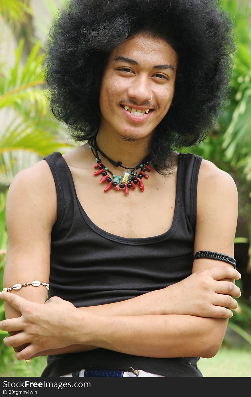 Thai man with a big afro hairstyle isolated on white.