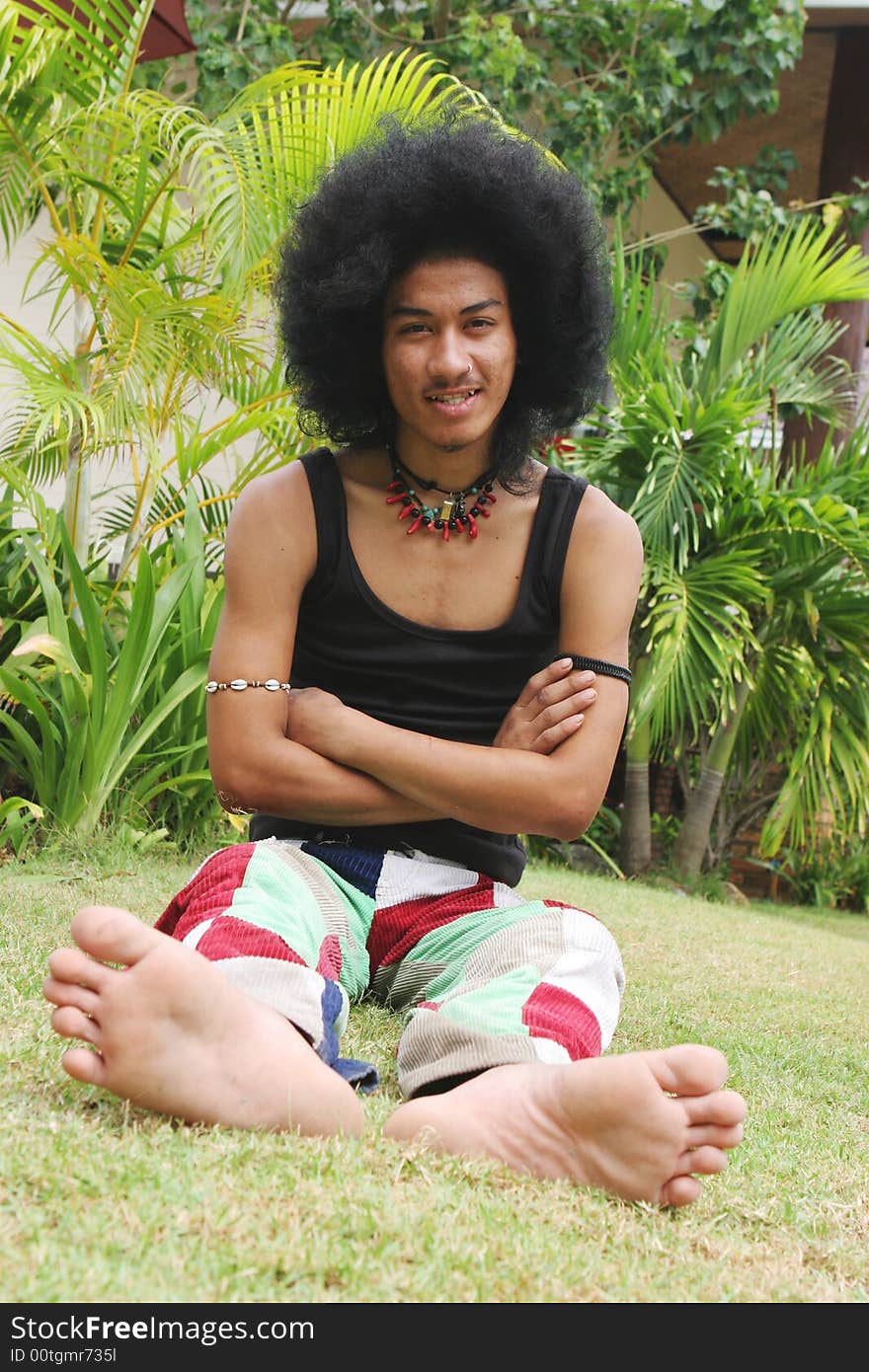 Thai man with a big afro hairstyle isolated on white.