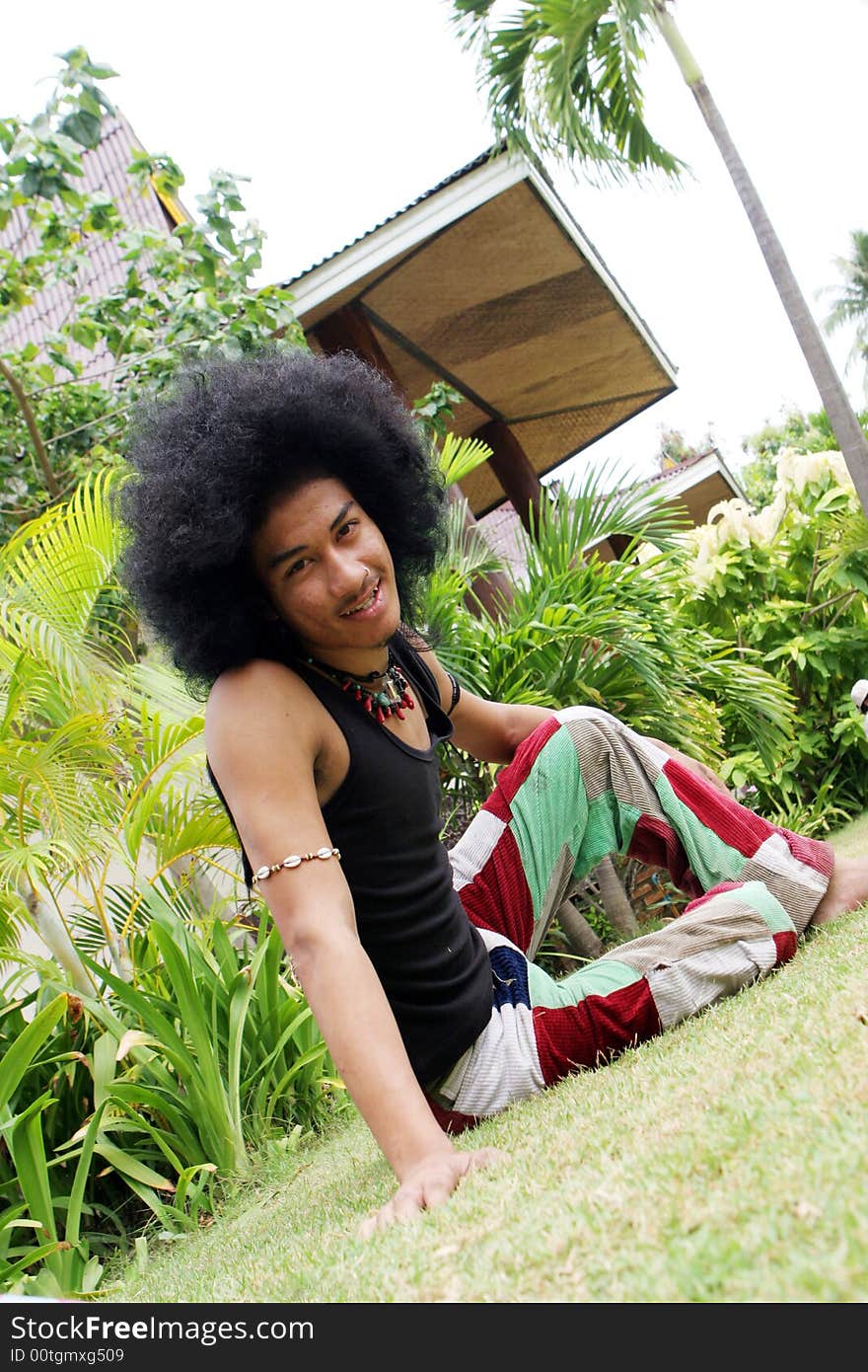 Thai man with a big afro hairstyle isolated on white.