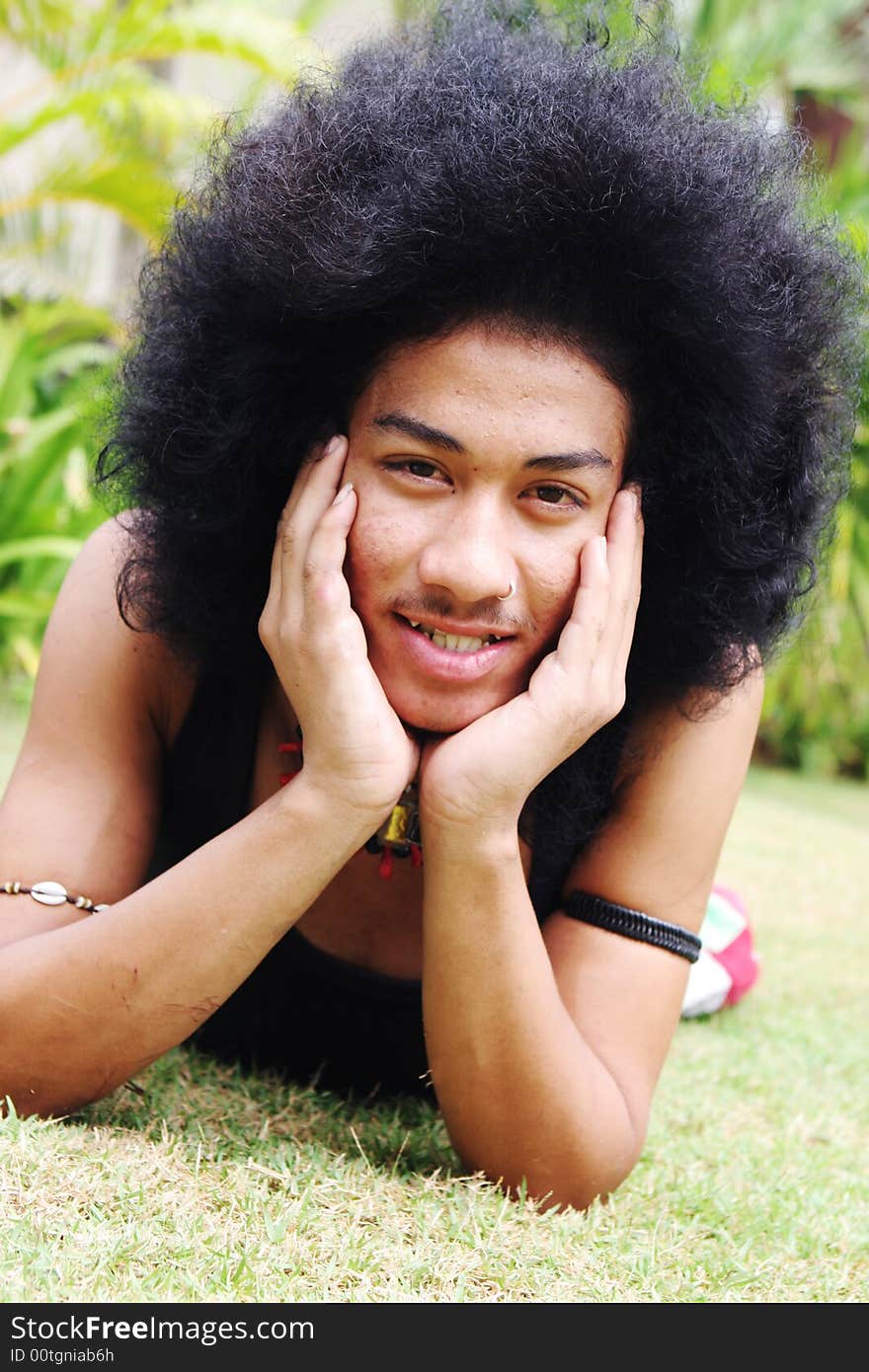 Thai man with a big afro hairstyle isolated on white.