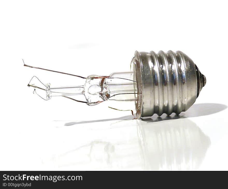 The burned-out light bulb on a white background. The burned-out light bulb on a white background.