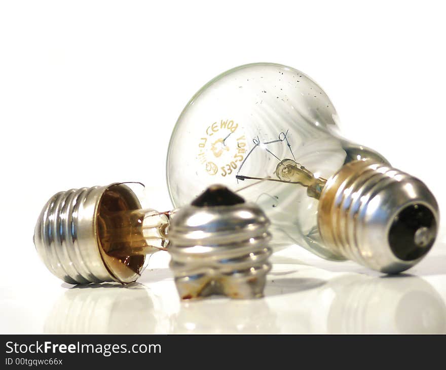 The burned-out light bulb on a white background. The burned-out light bulb on a white background.