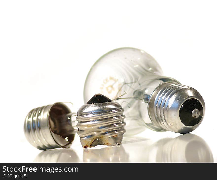 The burned-out light bulb on a white background. The burned-out light bulb on a white background.