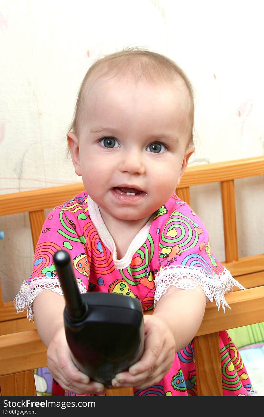 Lovely baby girl in pink dress with phone. Lovely baby girl in pink dress with phone