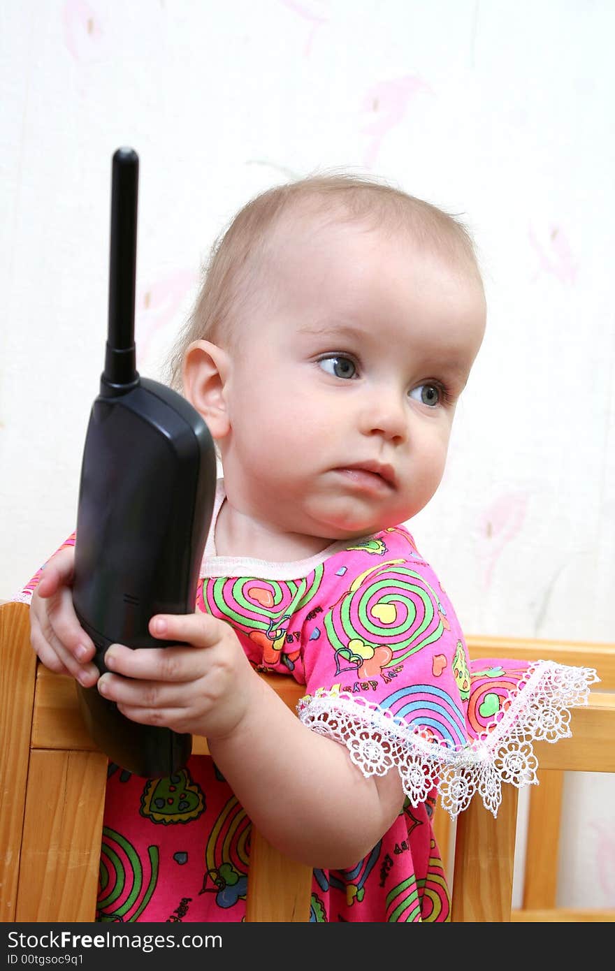 Lovely baby girl in pink dress with phone. Lovely baby girl in pink dress with phone