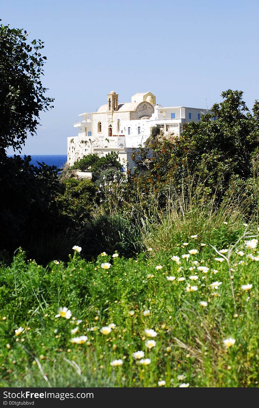 Flowers and shrubs in front of the monastery and sky as background. Flowers and shrubs in front of the monastery and sky as background