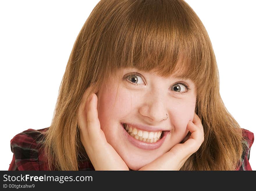 Close-up of a young woman with open smile and hands at the cheeks. Close-up of a young woman with open smile and hands at the cheeks.