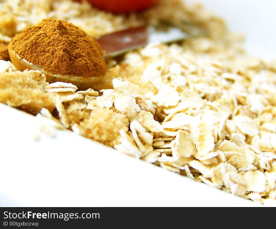 Image of a heaping spoonful of cinnamon, with brown sugar and oats.  Room for text or other material in bottom left of image.  Horizontal orientation. Image of a heaping spoonful of cinnamon, with brown sugar and oats.  Room for text or other material in bottom left of image.  Horizontal orientation.