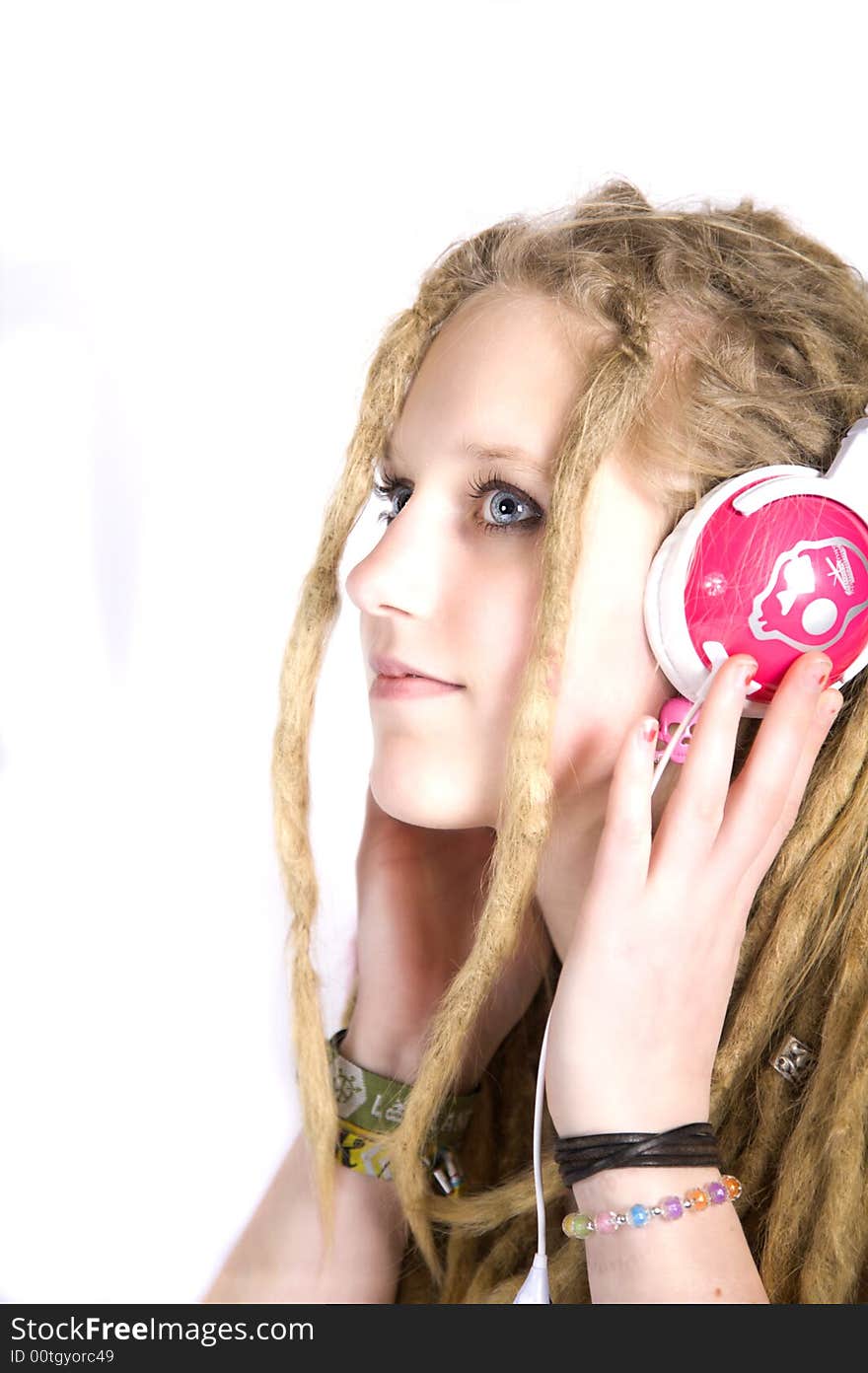 A beautiful blond girl listening to music. A beautiful blond girl listening to music