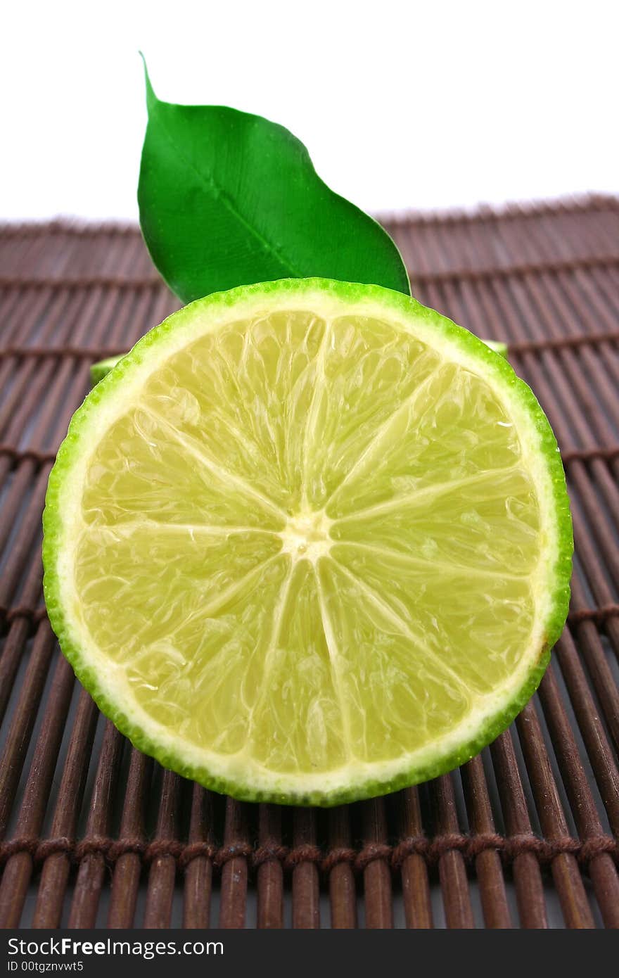 Healthy green lime fruit isolated on white