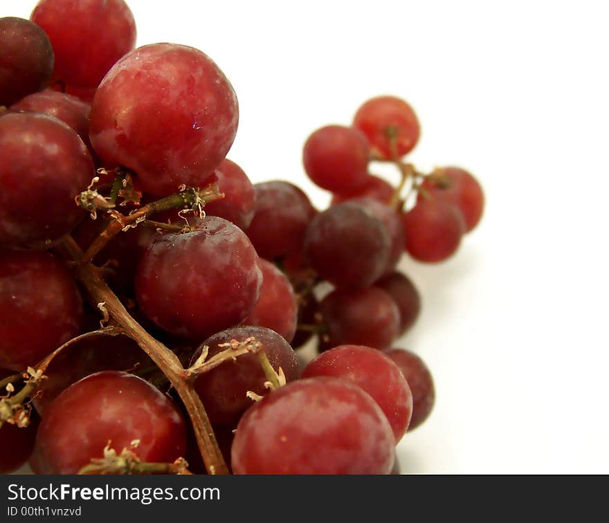 Close up image of red grapes isolated on white background.  Horizontal orientation. Close up image of red grapes isolated on white background.  Horizontal orientation.