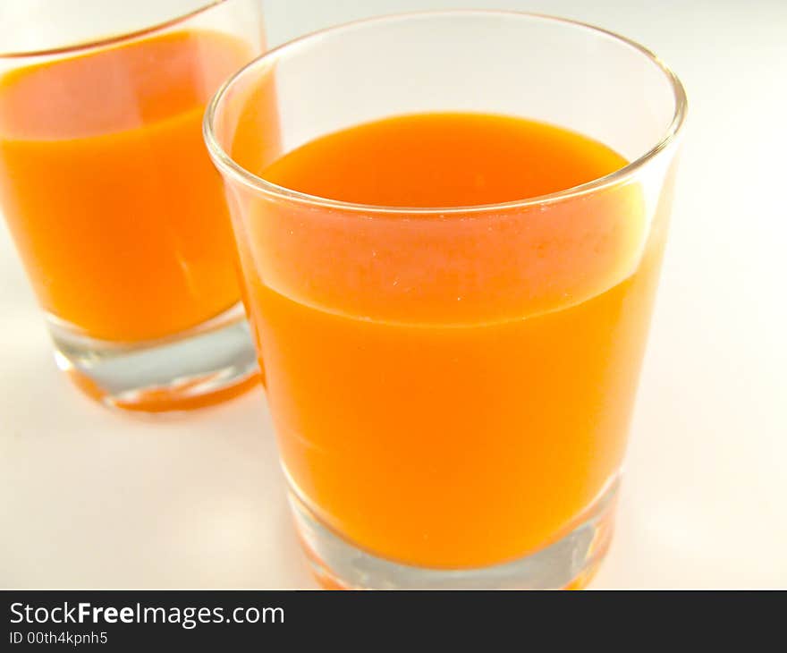 Glass of juice on white background