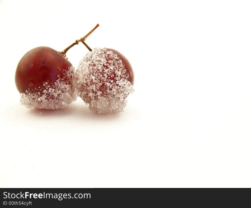 Image of two grapes joined together, dipped in granulated white sugar.  Horizontal orientation. Image of two grapes joined together, dipped in granulated white sugar.  Horizontal orientation.