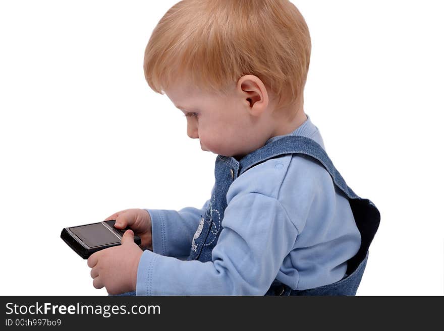 The small beautiful boy with curiosity examines a mobile phone. The small beautiful boy with curiosity examines a mobile phone