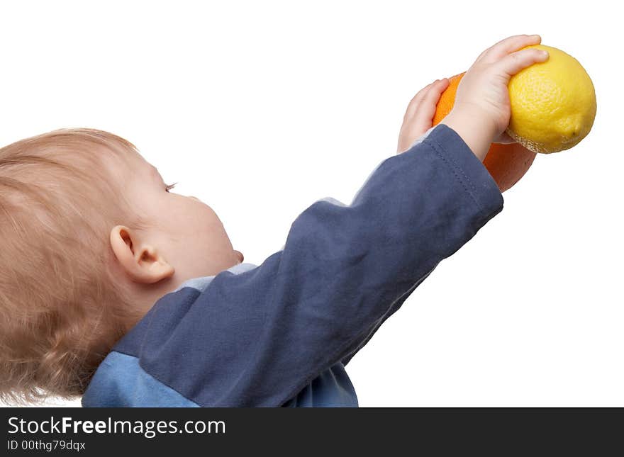 The child holds fruit