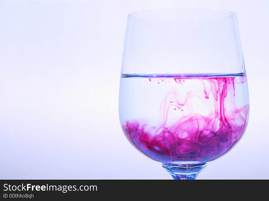 Coloured varicoloured wineglasses with reflections and red liquid. Coloured varicoloured wineglasses with reflections and red liquid