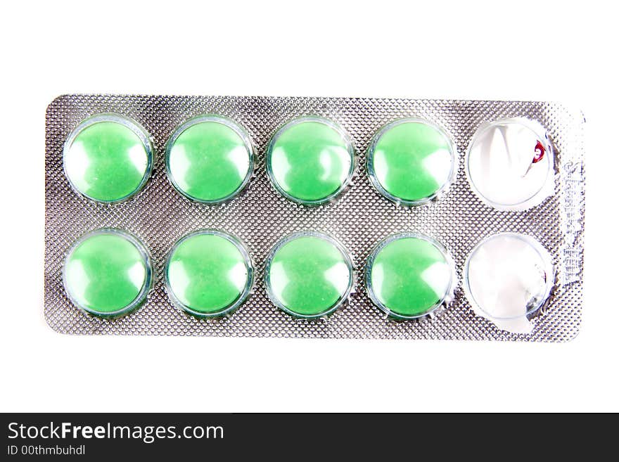 Green pills isolated on the white background